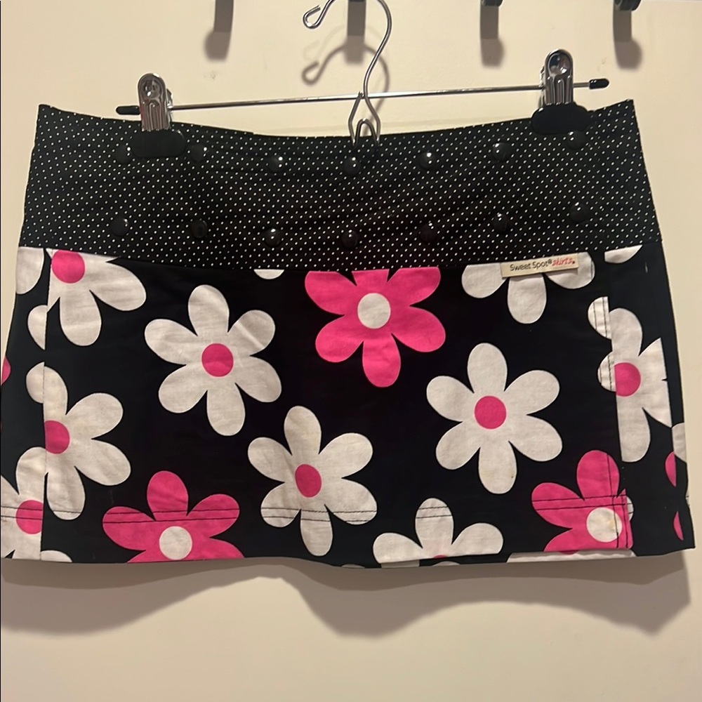 Never used Sweet Spot running skirt. One Size. Black with cute flowers.